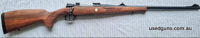 Made in Austria. Built on commercial Mauser 98 action. Chequered walnut stock with rubber butt pad. Blued sporter-profile barrel & action. Adjustable open sight
