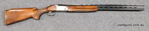 A Breda 12G U/O shotgun in good serviceable condition. This metal work reflects it age with the patina of use, and the stock has quite a few scratches which are