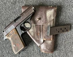 WWII Walther PPK, manufactured in 1938, with matching holster and spare mag, in very good condition with a high polish finish; some thinning on the edges. excel