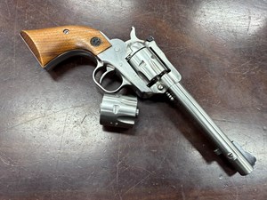 RUGER
SINGLE SIX
22LR / 22WMR
6 SHOT
TWO CYLINDERS
5.5 INCH BARREL
STAINLESS STEEL
ORIGINAL RUGER TIMBER GRIPS
WITH EMBLEM
ADJUSTABLE REAR SIGHT
"MADE IN THE 200TH YEAR OF
AMERICAN LIBERTY" FACTORY ENGRAVED
IN THE TOP OF THE BARREL
MANUFACTURED 1976
#64-35422

VGC+ $690