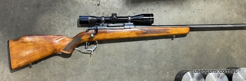 This old Cooey version of the Model 70 has a blind floor plate and a simple stock. It is in fair condition with a lot of bluing worn off and a worn barrel.