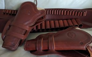 These leathers are made by Rick Bachman of Old West Reproductions, very well made. Pistol belt is in 38/357 and is 34 - 38 inches shotgun belt is 12 gauge and 2