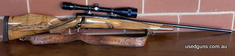 This Nikko model 7000 Golden Eagle is a bolt-action rifle with a fixed magazine that takes 22-250 Winchester rounds. The rifle was produced by Nikko Ltd. a Japa
