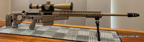 Accuracy International AXMC chambered in 338 lap, pale brown, 27" barrel length, 1 in 9.35" twist, tactical muzzle brake, folding stock. Fired 370 rounds at the