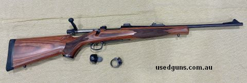 Surplus to the requirements, laminate stock with iron sights and return to zero swing mounts.