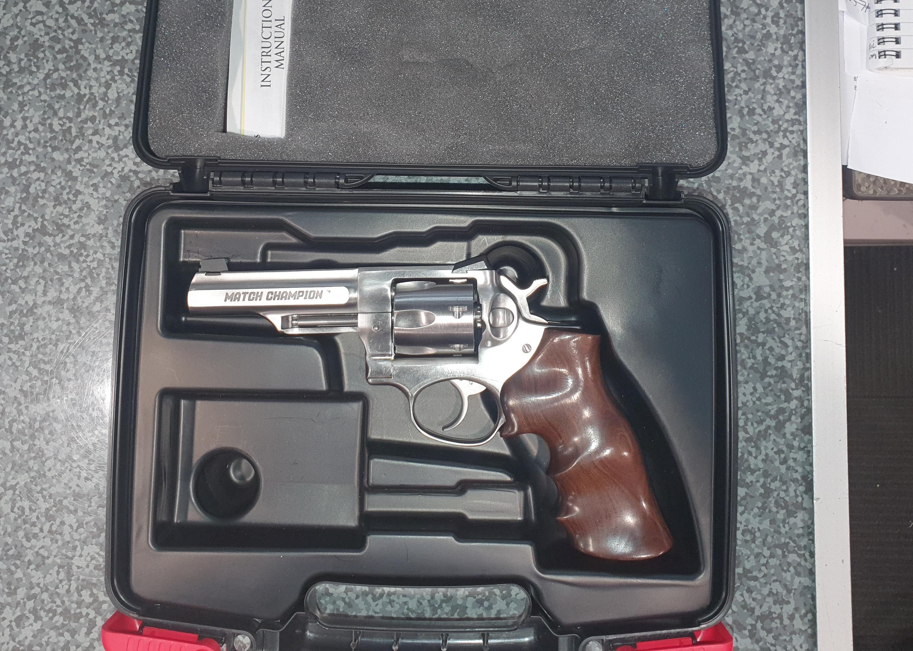 Ruger GP100 with original case, paperwork and aftermarket grips.