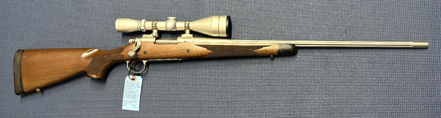 Very good condition Remington 700 in 223. Has a stainless steel fluted barrel and action. Lovely wood stock. Would be excellent if not for some damage to the bu