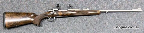 FN Commercial 98 in 7mm Rem Mag. Custom made stock with very highly figured walnut. 24 inch barrel with barrel band and open sight. All metalwork has been cerak