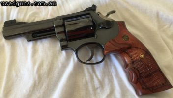 This is a Smith & Wesson Model 19-3 in excellent condition. It has a 4-inch barrel with a partridge front sight. It has been restored and re-blued by Hansen Cus