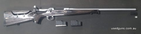 Laminated timber stock with adjustable cheek piece, Silver Ilaflon Coating, threaded barrel, comes with 2 magazines and genuine Sauer muzzle brake. Great rifle,