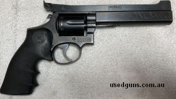 S&W model 14-2 with a 6" slab barrel, trigger job and older type Aristocrat tri-set sight rib, holster wear and scratches.