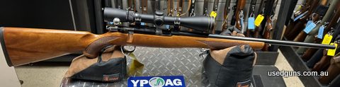 Ruger 77/22 wood stock with a blued barrel. In good condition. 9 shot magazine. Leupold Rifleman 4-12x40