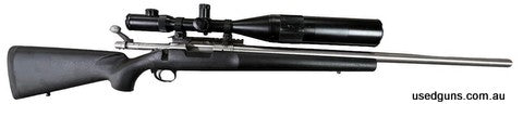 Remington 40-X with custom stainless heavy barrel in 6mm Rem. in Good condition with marks and blemishes on stock. Comes with a Nightforce 8-32x56 scope.