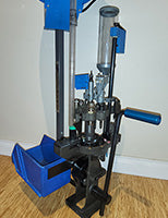 Dillon Super 1050 for rifle and pistol reloading. Eight stations - insertion, size deprime, swage, prime, powder drop, powder check system, bullet seat, crimp. 