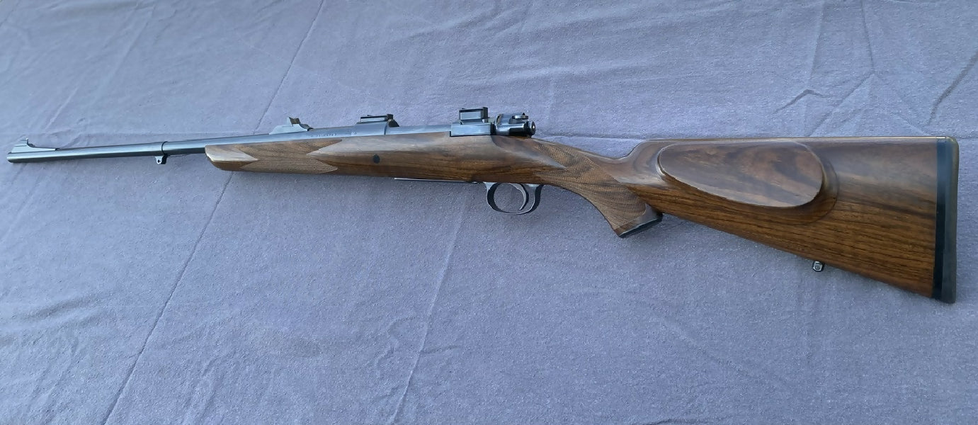 Husqvarna 9.3, re-stocked in tough Australian English Walnut, cross bolt, custom iron sights, Talley bases, Wisner 2 position safety, Timney trigger.