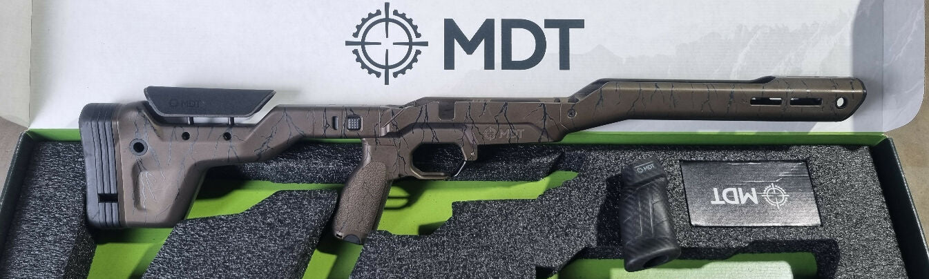 MDT HNT26 chassis to suit R700 RH short actions, folding stock, Cerakoted Midnight Bronze with Black lightning bolts. Stock spacers and spare carbon fibre grip 