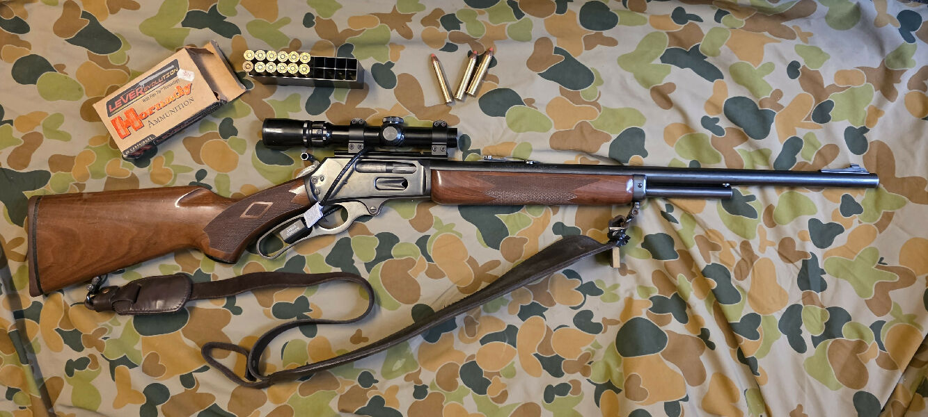 .444 Marlin. Has been a great scrub gun for pigs, goats, and deer. Comes with better part of a case of leverevolution ammo, Weaver 1.5-3x scope, and some spare 