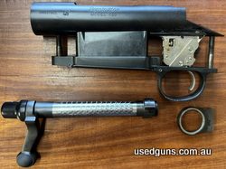 Remington 700 Action, factory trigger, Nickle coloured bottom metal, recoil lug, action screws, 223 bolt face.