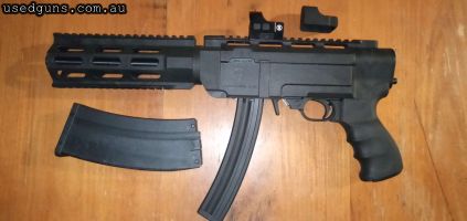 Very accurate Charger 22 in Archangel 5.56 chassis and MP5 lookalike 10rd mag with 223 look sleeve. Comes with Bushnell Reflex sight, manual, original charcoal 